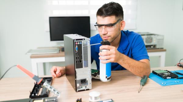 Man cleaning CPU with compressed air